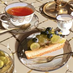 there is a plate with grapes and bread on it next to two cups of tea