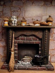 a fire place with a broom, potted plants and other items on it