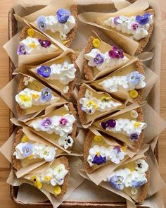 there are many pieces of bread with edible flowers on them in the box, ready to be eaten