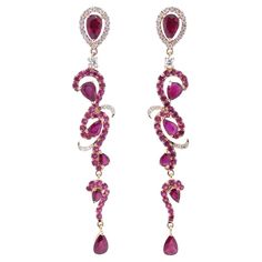 These exquisite Ruby Drop Dangle Earrings are a true statement of luxury and grace. The intricate design, set in 18k rose gold, features a brilliant combination of 84 sparkling diamonds and 54 vibrant rubies, making them the perfect blend of elegance and boldness. Elevate your style with these earrings that capture attention effortlessly. Earring Information Diamond Type : Natural Diamond Metal : 18k Metal Color : Rose Gold Number of Diamonds : 84 Number of Rubies : 54 Total Gold Weight : 6.96 g Elegant Rose Red Earrings For Party, Elegant Ruby Jewelry In Pink Gold, Elegant Pink Gold Ruby Jewelry, Elegant Ruby Bridal Earrings For Party, Red Diamond Earrings For Party, Red Diamond Party Earrings, Elegant Rose Red Dangle Jewelry, Jewelry Ruby, Gold Number