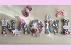 there are many magnets that spell out the word mom in pink and grey colors