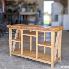 a wooden table with shelves on the top in a room filled with other furniture and tools