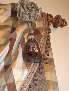 a close up of a curtain with an animal head hanging from it's side