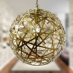 a ball shaped light fixture hanging from a ceiling