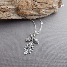 "sterling silver oak leaf two acorns necklace, 3/4\" - A small solid sterling silver charm, measuring just over 3/4\" long (22 mm), 1/2\" (12 mm) across at widest point.   - Necklace is 1.5 mm cable chain, with lobster clasp and locking jump rings, all solid sterling silver.  - Front design is realistic looking, blackened (oxidized) to bring out the details, back smooth with hollowed acorns, tiny 925 mark. - With sustainability in mind, charm is made from 100% post-consumer recycled sterling silver. - Packaged in a modern circular tin, ready for gift giving, and comes with a silver polish pad and care instructions. Customize chain length or \"charm only\" option: - Charm only option, no chain. Charm does include a top ring. - Chain length: Choose a set length from the drop down menu or cho Acorns Necklace, Acorn Jewelry, Acorn Necklace, Fall Trees, Silver Oak, Silver Polish, Precious Metal Clay, Top Rings, Leaf Jewelry