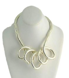 Flexible necklace that has been designed to bend or twist in different shapes. It is slightly rigid so you hold the shape. It can even been worn as a wrap bracelet. Measures 29 inches when folded in half. Measures 58 inches all around. Made of stainless steel silver color. Measures 1/2 inch in thickness. Bendable Necklace, Different Shapes, Wrap Bracelet, Bend, Silver Color, Twist, Stainless Steel, Bracelet, Silver