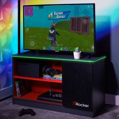 a flat screen tv sitting on top of a wooden entertainment stand in front of a colorful wall