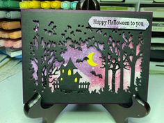 a handmade halloween card with a house in the woods