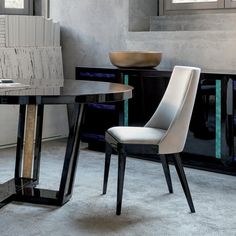 a modern dining table with two chairs next to it