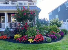 a house with flowers in the front yard