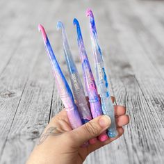 a person holding four toothbrushes in their hand