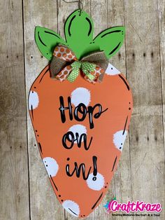 a wooden sign that says, hop on an orange with polka dots and a bow