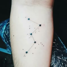 a small star tattoo on the arm