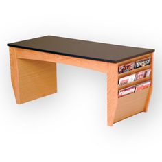 a wooden desk with magazines on it and a black shelf underneath the desk top that holds several books