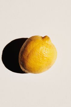 an orange sitting on top of a white table