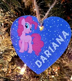 a heart shaped ornament hanging from a christmas tree with the name darana on it