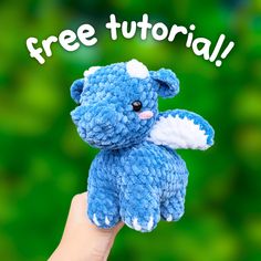 a hand holding up a small blue teddy bear with the words free tutor on it