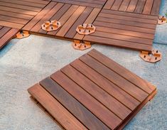 several pieces of wood laid out on the ground to be used as floor coverings