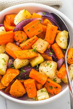 roasted root vegetables in a white bowl with a spoon and title text reads roasted root vegetables little sunny kitchen