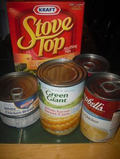 several cans of canned food on a counter top next to a box of stove top