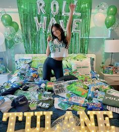 a woman sitting on top of a bed in front of balloons and letters that spell out the word tune