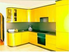 a kitchen with yellow cabinets and black counter tops is pictured in this image from the front view