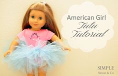 the american girl doll is wearing a blue tutu skirt and pink t - shirt