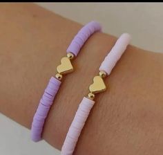 two bracelets that have hearts on them and one has a gold heart in the middle