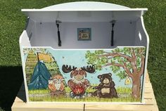 an ice chest painted with animals and trees