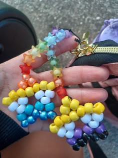 a person holding several colorful beads in their hand