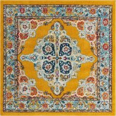 an ornate yellow rug with blue, red and orange flowers on the center is surrounded by multicolored floral designs