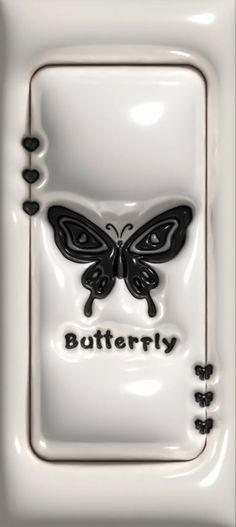 a white plate with a black butterfly on it's face and the words butterfly