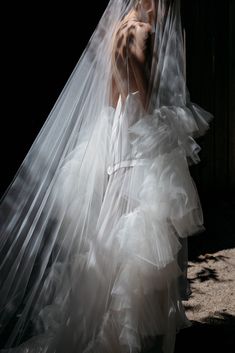 a woman in a white wedding dress and veil