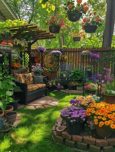 an outdoor garden with lots of flowers and potted plants