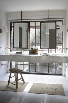 a large bathroom with two sinks and mirrors