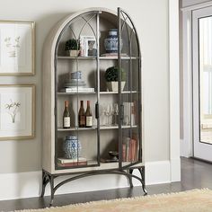 an arched glass display cabinet in a living room