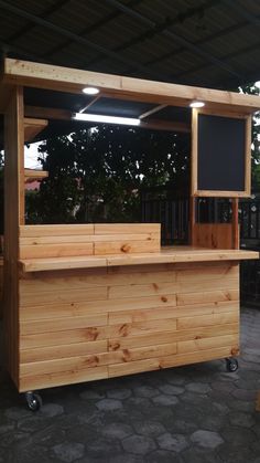 a large wooden bar sitting on top of a sidewalk