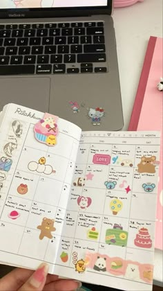 someone is holding an open planner with stickers on it