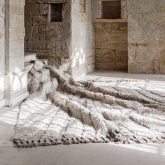 the sun shines through an old stone building