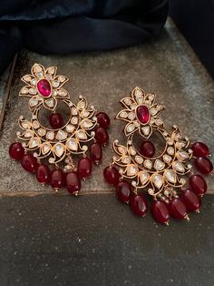 These antique Red Kundan earrings with red droplets will add the perfect charm to your festive wear. Length 8 cms Width 5.7 cms Weight 68 grams a pair Red Earrings Indian, Traditional Red Pearl Earrings For Party, Red Round Pearl Drop Earrings, Red Pearl Drop Round Earrings, Elegant Red Chandelier Earrings For Festive Occasions, Elegant Red Festive Chandelier Earrings, Festive Red Elegant Chandelier Earrings, Red Earrings For Formal Festive Occasions, Formal Red Pearl Earrings With Matching Set