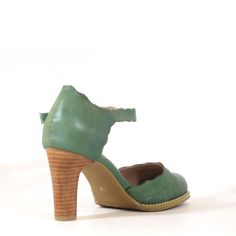 The perfect simple (yet funky) heels! Made in the colors we find to be most useful, these vintage inspired high heels are radiating beauty with the scallop detail and our flower closure! Upper: Faux Leather Velcro closure Leather lining Heel height: 3.5" Vintage Green Round Toe Heels, Spring Court Shoes With Wooden Heel And Closed Toe, Vintage Green Heels With Round Toe, Mary Jane Open Toe Heels With Sculpted Heel, Mary Jane Heels With Sculpted Heel And Open Toe, Retro High Heels With Heel Strap, Retro High Heel With Heel Strap, Retro Heels With Heel Strap And High Heel, Spring Vintage Round Toe Heels