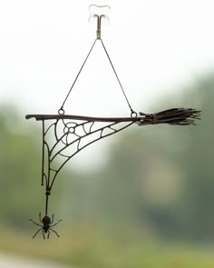 a spider web hanging from the side of a window