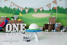 a golf themed birthday party with cake and decorations on the table, including a hat