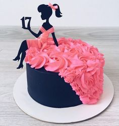 the cake is decorated with pink flowers and an image of a woman holding a book