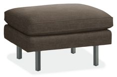 a brown ottoman with metal legs on an isolated white background