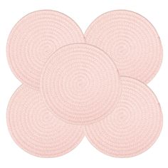 four round rugs in pink on a white background