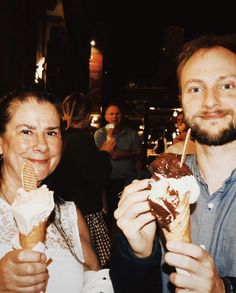 two people are eating ice cream and smiling