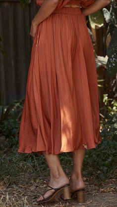 Even though this Woven Satin Long Midi Skirt is a pre-fall piece, it can be worn year round. This beautiful satin silk skirt has that perfect classic fit. Orange-color. Lined. Satin fabric. Side pockets. Full circle skirt. Woven Satin Long Midi Skirt fits true to size. By Together LA. **Skirt for sale only, top not available. Woven Satin Long Midi Skirt Measurements: Small measures 30" overall length. Medium measures 31" overall length. Large measures 32" overall length. 100% Poly, lining 100% R Bohemian Pleated Midi Skirt, Rayon Pleated Midi Skirt, Silk Full Skirt With Gathered Detail, Rayon Midi Pleated Skirt, Summer Tiered Skirt With Folds, Spring Tiered Skirt With Folds, Long Rayon Lined Skirt, Silk Long Skirt For Fall, Relaxed Silk Skirt For Fall