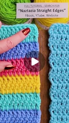 a woman's hand is pointing at a crocheted square