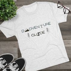 Dads will love to wear this t-shirt showing everyone how much they love to enjoy the outdoors with their kids! Dads lead us in all kinds of adventures, through the woods and the mountains and waters, hiking and climbing and kayaking, enjoying time with their kids! Celebrate being an adventure Dad with this Dadventure Guide shirt! This high quality regular fit tee has a casually elegant vibe. Additionally, unbelievably soft tri-blend fabric makes it extremely comfortable - once put on, impossible to take off. .: 50% polyester, 25% combed ringspun cotton, 25% rayon .: Light Fabric (4.3 oz/yd (146 g/m)) .: Regular fit .: Sewn-in label Pre-shrunk Tri-blend T-shirt For Outdoor Activities, Casual Tri-blend T-shirt For Adventure, Adventure T-shirt With Letter Print And Short Sleeves, Adventure Letter Print Short Sleeve T-shirt, Short Sleeve Tops With Text Print For Adventure, Short Sleeve T-shirt With Letter Print For Outdoor Activities, Graphic Tee Shirt With Letter Print For Outdoor Activities, Graphic Tee With Text Print For Outdoor Activities, Graphic Tee For Outdoor Activities With Moisture-wicking